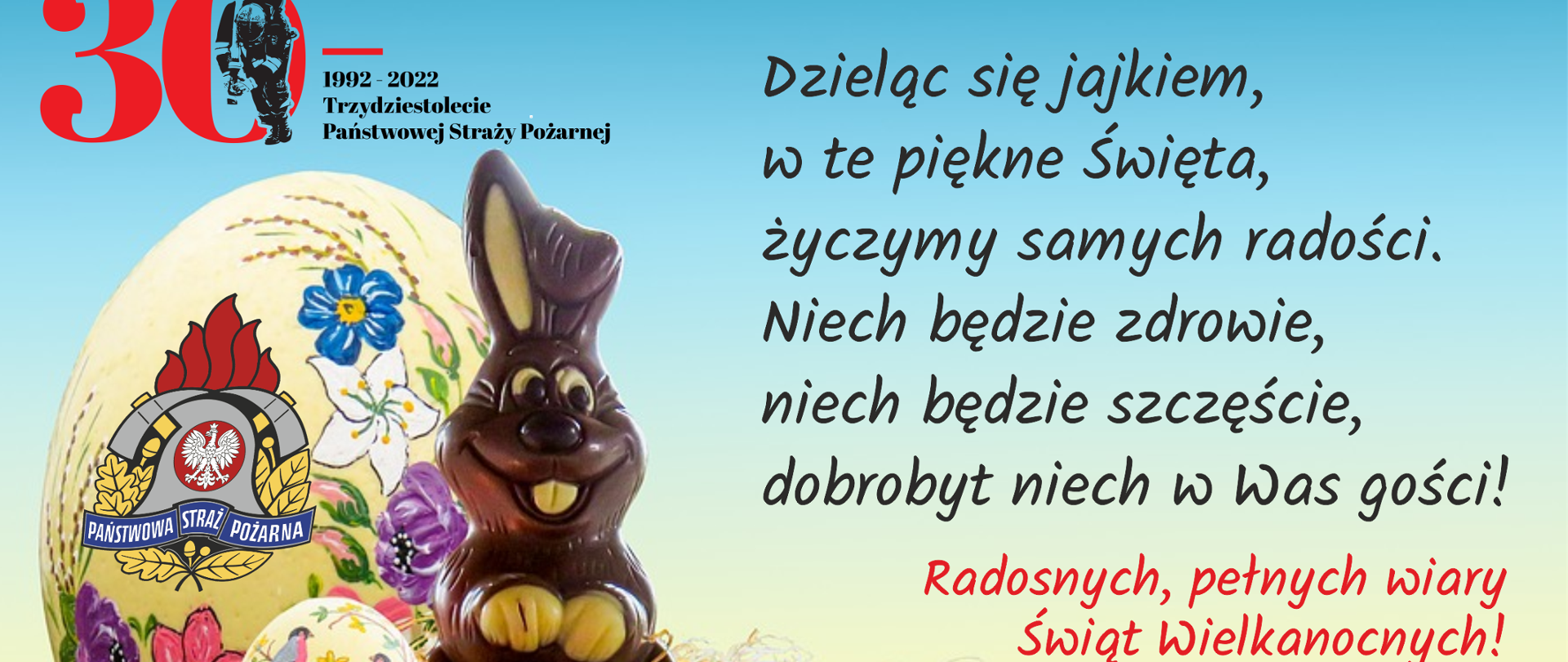 Na zdjęciu widnieje grafika przedstawiająca pisanki, zająca z czekolady oraz tekst: "Dzieląc się jajkiem w te piękne święta, życzymy samych radości. Niech będzie zdrowie, niech będzie szczęście, dobrobyt niech w Was gości! Radosnych, pełnych wiary Świąt Wielkanocnych życzą kierownictwo, funkcjonariusze i pracownicy cywilni Komendy Wojewódzkiej Państwowej Straży Pożarnej w Kielcach."