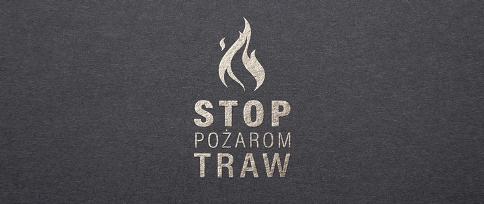 Zdjęcie przedstawia biały napis na ciemnoszarym tle: "Stop pożarom traw". Nad napisem symbol płomienia.