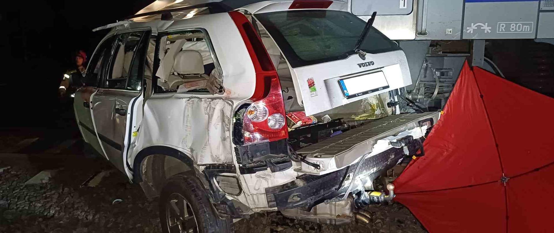 Rozbity samochód stojący na torach.