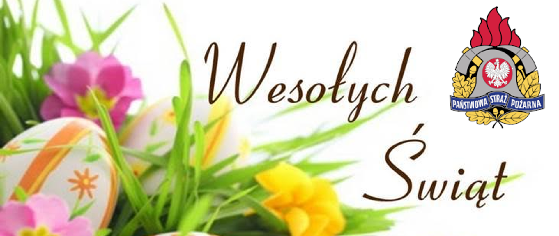 Kolorowe pisanki ułożone na zielonej trawie z kwiatami. Obok napis Wesołych Świąt. W prawym górnym rogu znajduje się logo PSP