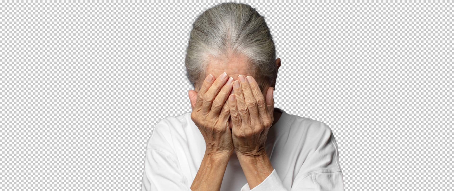 kobieta zasłania oczy rękami w smutku