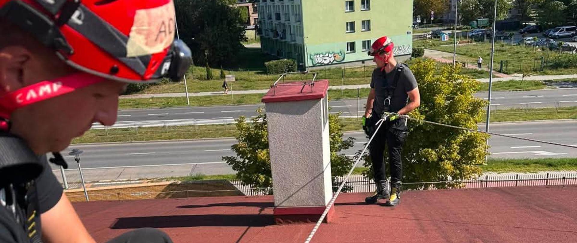 Zabezpieczeni strażacy podczas ćwiczenia na dachu