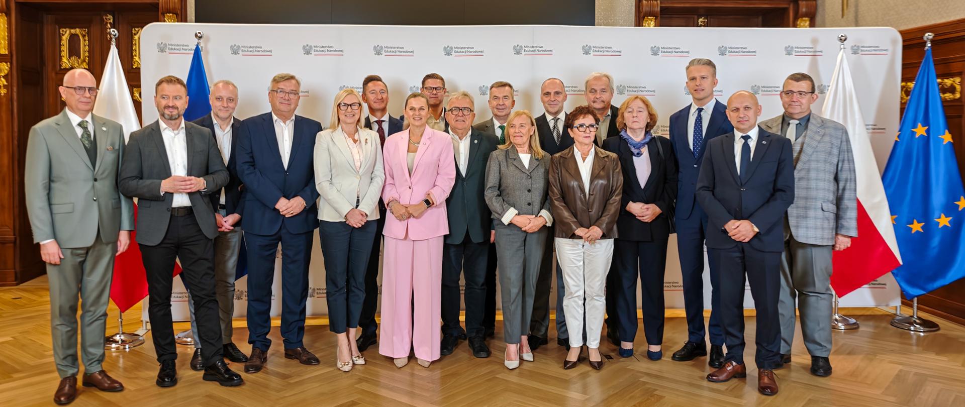 Zdjęcie grupowe na ściance Ministerstwa Edukacji Narodowej