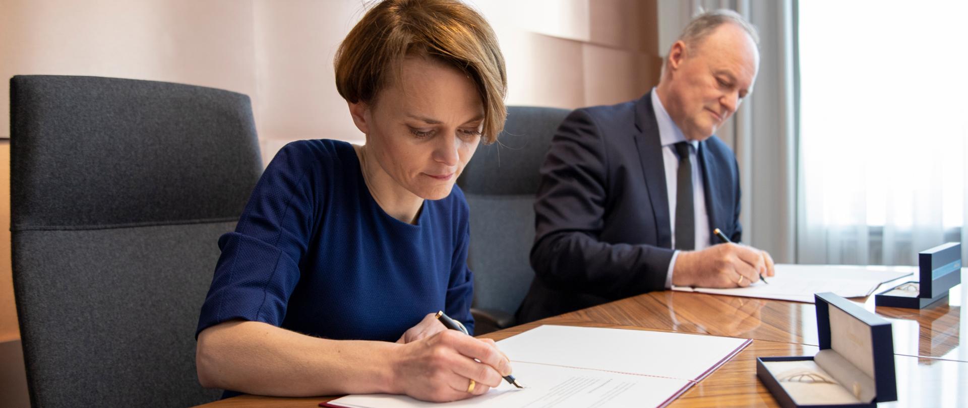 Minister Emilewicz i przedstawiciel Opla podpisują umowę 