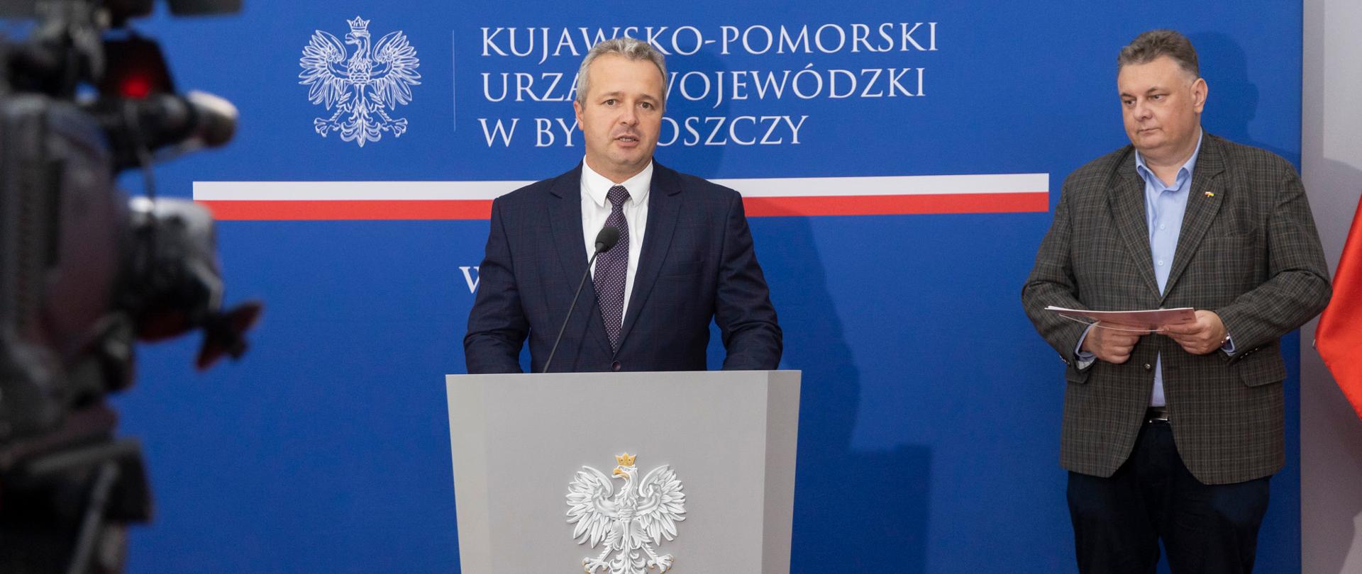 Jeden mężczyzna stojący przy mównicy i wypowiadający się 