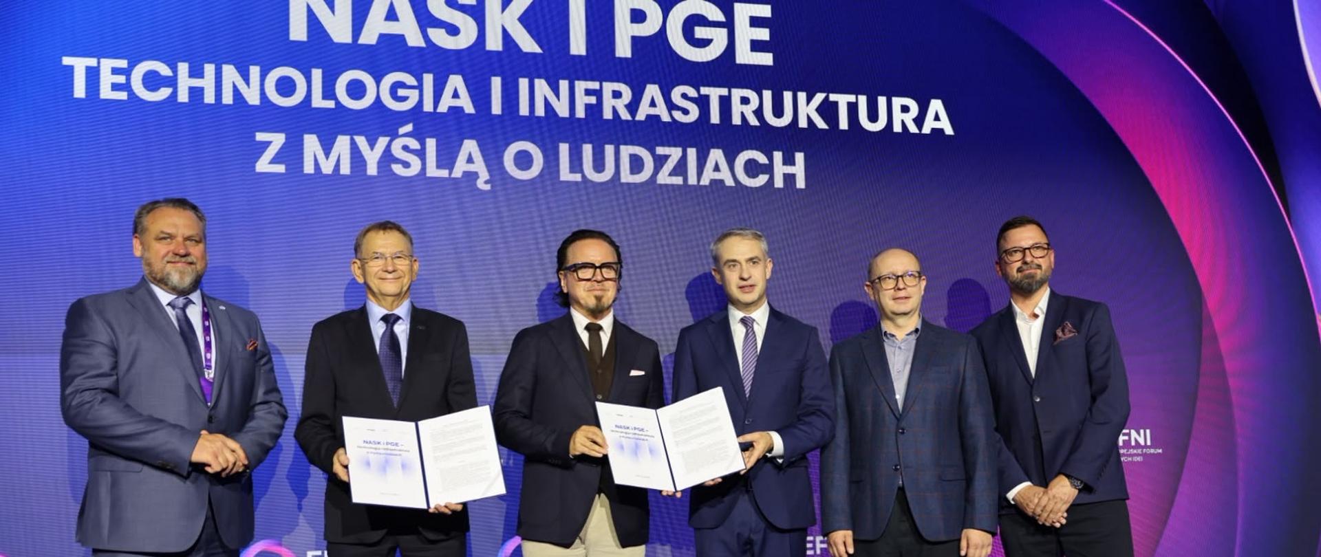 Minister Wojciech Balczun oraz wicepremier, minister cyfryzacji Krzysztof Gawkowski i inni uczestnicy spotkania podczas podpisania umowy pomiędzy NASK i PGE Polska Grupa Energetyczna S.A. dotyczącej realizacji inwestycji w centra danych w Polsce.