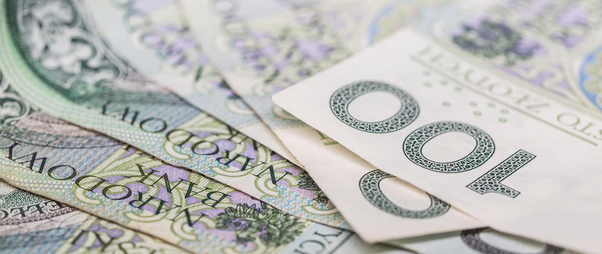 Zbliżenie na banknoty o nominale 100 złotych.