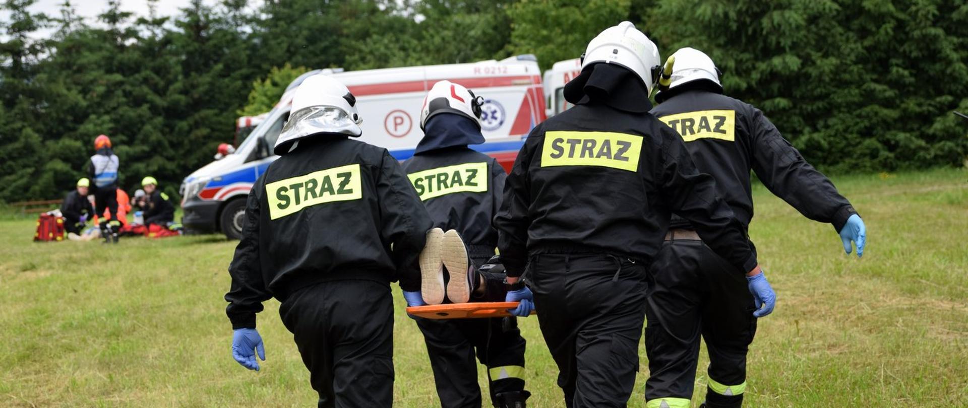 Zdjęcie zrobione na zewnątrz, w trakcie wojewódzkich ćwiczeń ratowniczych w Jaśle. Strażacy realizują założone ćwiczenia.