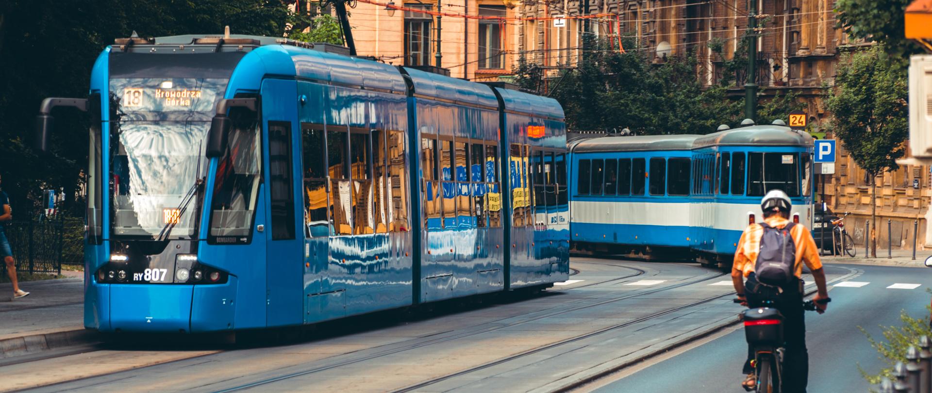 Krakow, Poland - 26 june 2019: The modern tram on the street of Krakow. Public transport. People waiting for the tram at bus stop. Transportation concept.