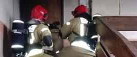 Dwóch strażaków na klatce schodowej