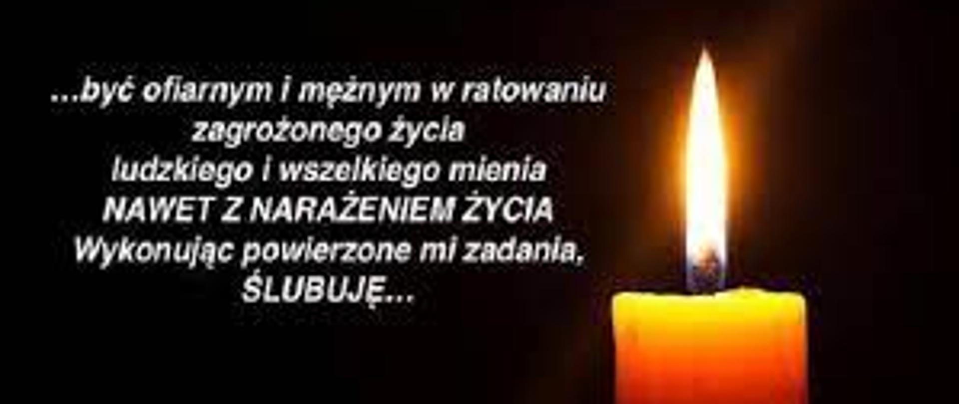 Zapalona świeczka na czarnym tle z rotą ślubowania 