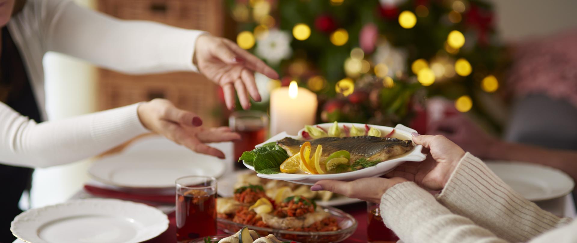 People passing plate with Christmas carp