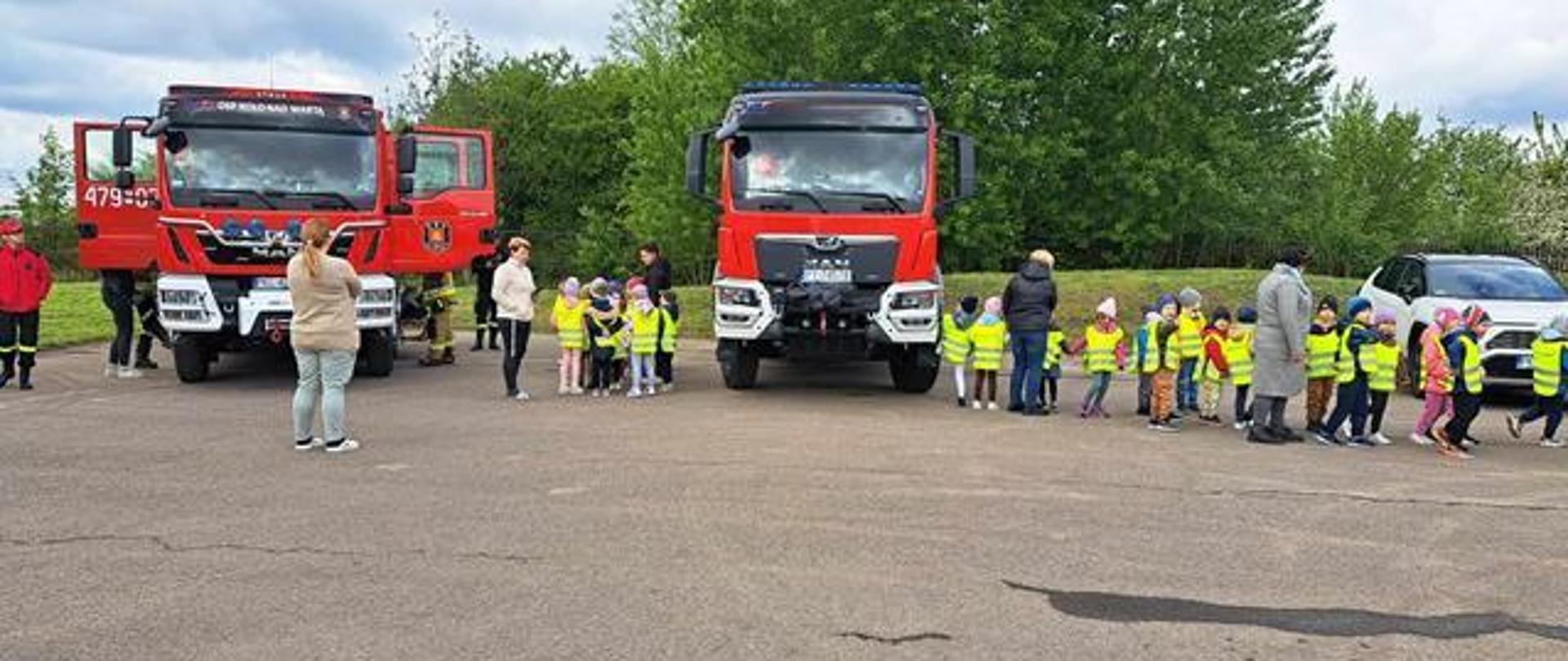 Dzieci na tle samochodów pożarniczych