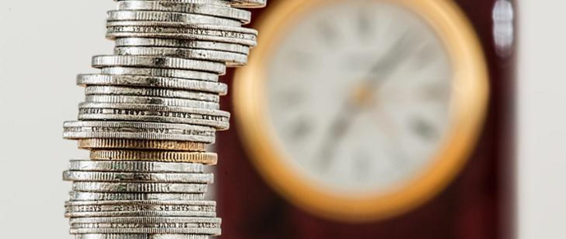 time is money - clock with a stack of coins