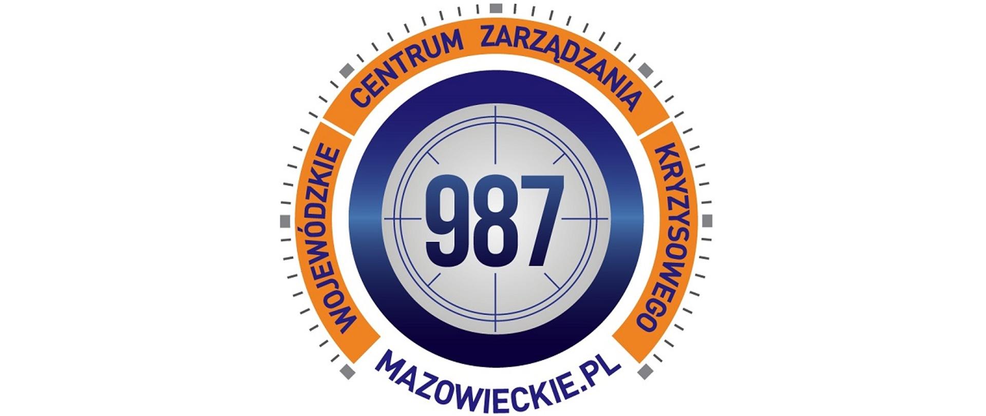 Grafika przedstawia logotyp Wojewódzkiego Centrum Zarządzania Kryzysowego, w szarym kole z granatowym obwodem wpisany numer infolinii 987, na około numeru w pomarańczowym obwodzie napis Wojewódzkie Centrum Zarządzania Kryzysowego. Całość wygląda jak tarcza zegara. 