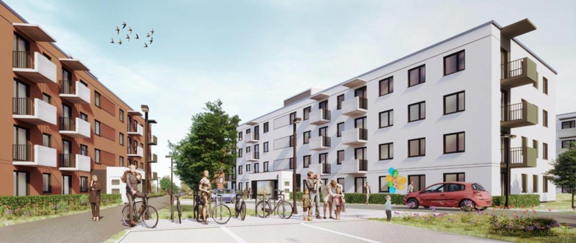 w tle bloki z przodu zaaranżowany plac i stojaki na rowery