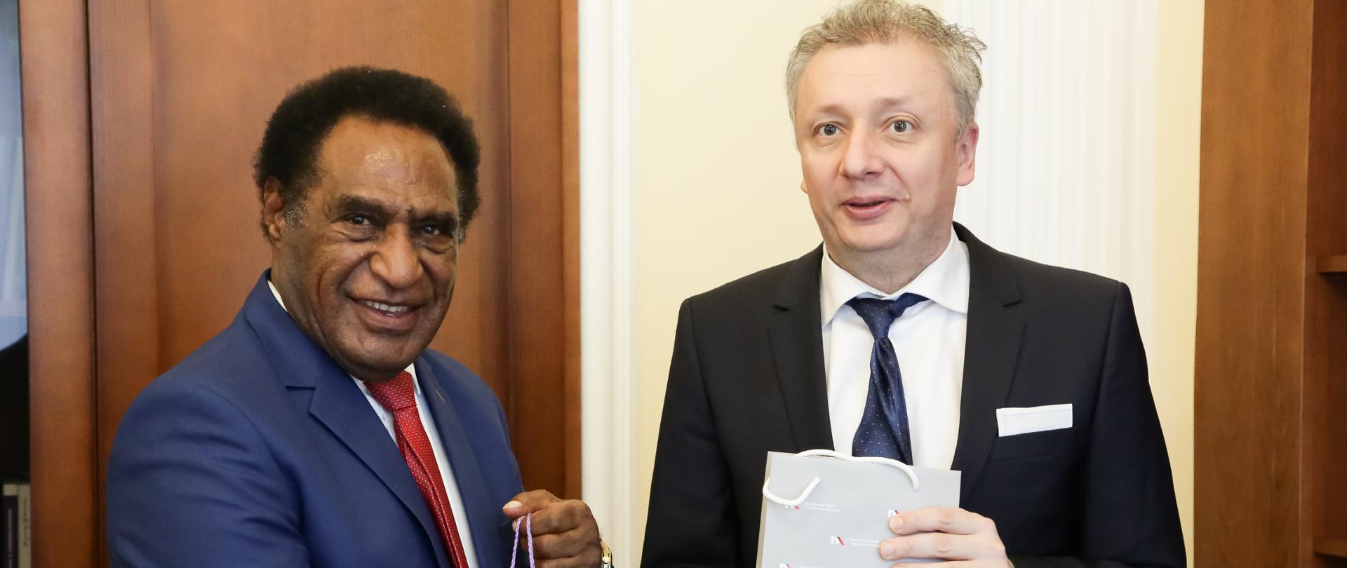 Na zdjęciu widać wiceministra Sebastiana Skuzę podczas uścisku dłoni z wiceministrem nauki i szkolnictwa wyższego z Papui-Nowej Gwinei.
