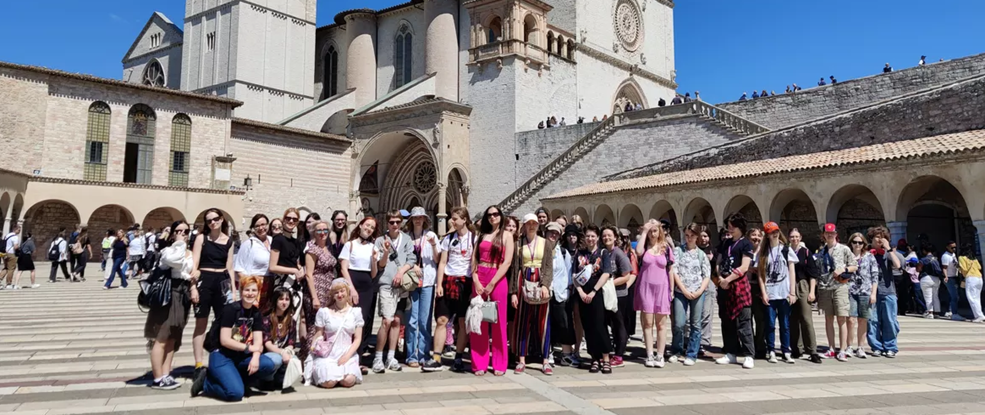 Fotografia z wyjazdu zabytkoznawczego pn. :Bella Italia prezentująca na pierwszym planie uczestników wyjazdu, na drugim zabytkowy obiekt z trasy wycieczki.