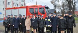 Uczestnicy uroczystości na tle nowego samochodu gaśniczego