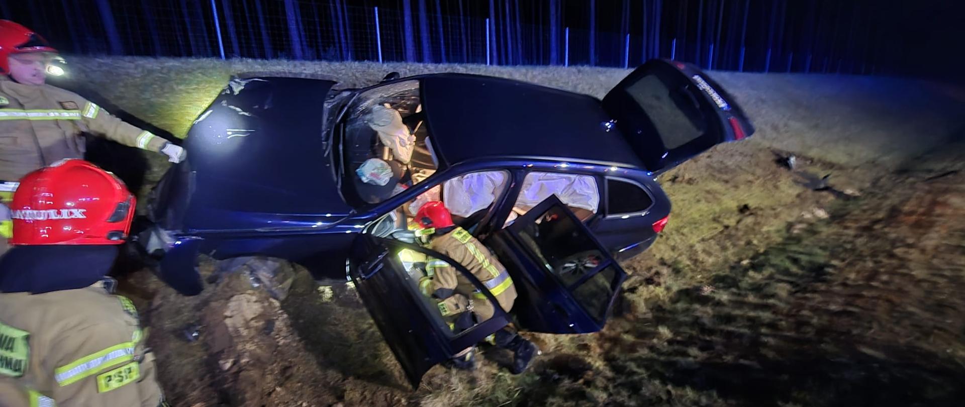 Samochód osobowy znajdujący się na skarpie przy autostradzie