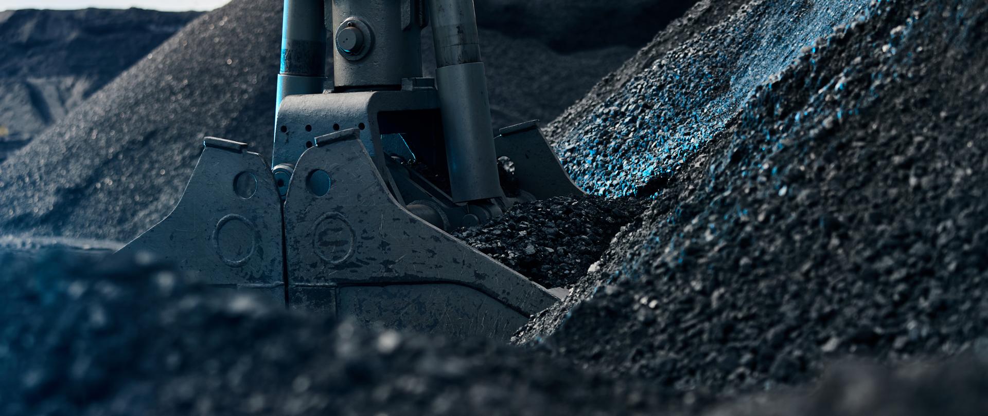 Coal loading excavator, heaps of coal