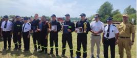 Zdjęcie przedstawia ustawienie się kapitanów drużyn OSP po dekoracji na zakończenie zawodów sportowo- pożarniczych
