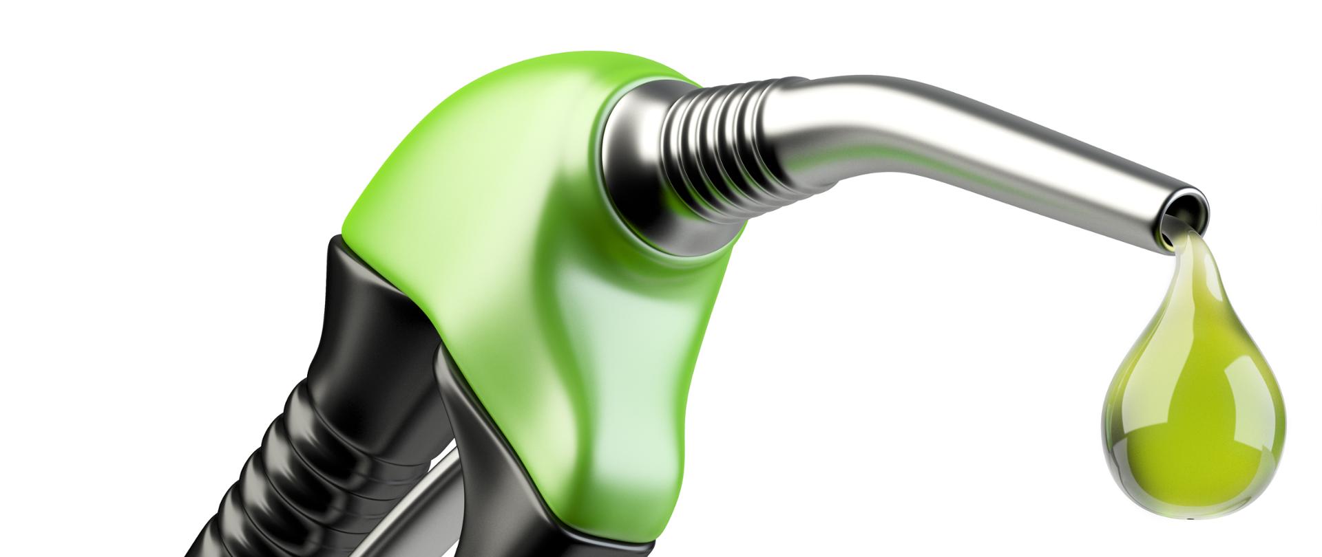 Green fuel pump nozzle with drop oil. Bio fuel concept.