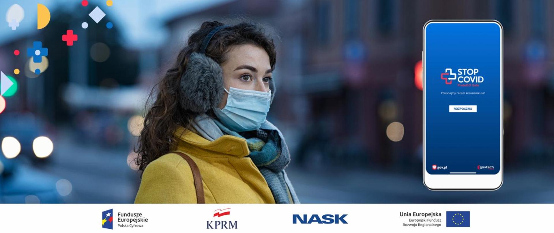 Baner w tonacji niebieskiej przedstawiający kobiete w masce oraz telefon typu smartfon z uruchomioną aplikacją StopCOVID.