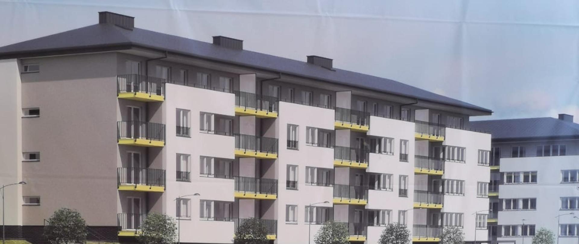 W tle biały blok z szaro-zółtymi balkonami. Na pierwszym skwer zieleni z bawiące się latawcem dwójką dzieci