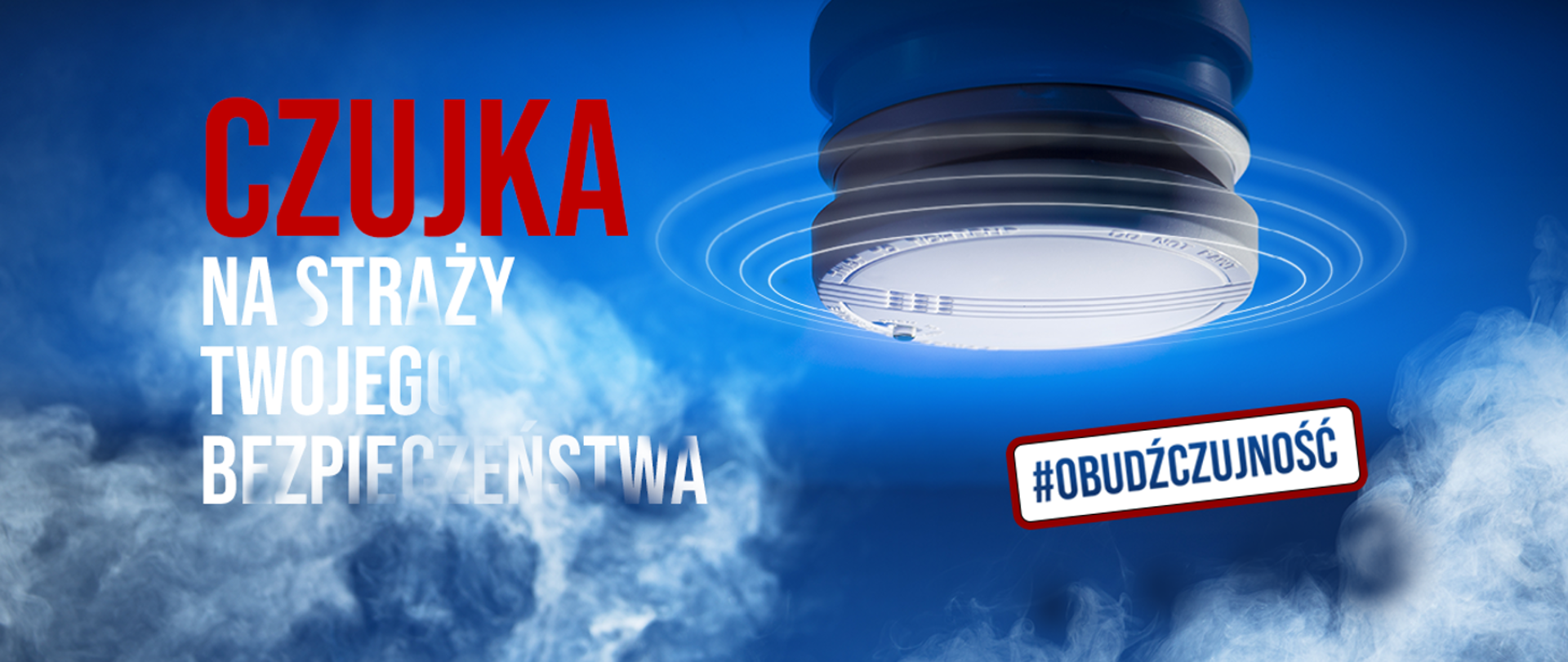 Baner na niebieskim tle. Napis po lewej stronie: Czujka na straży Twojego bezpieczeństwa. Po prawej stronie obrazek czujki a pod nim napis: #obudźczujność. Od dołu baneru umieszczona jest grafika dymu.