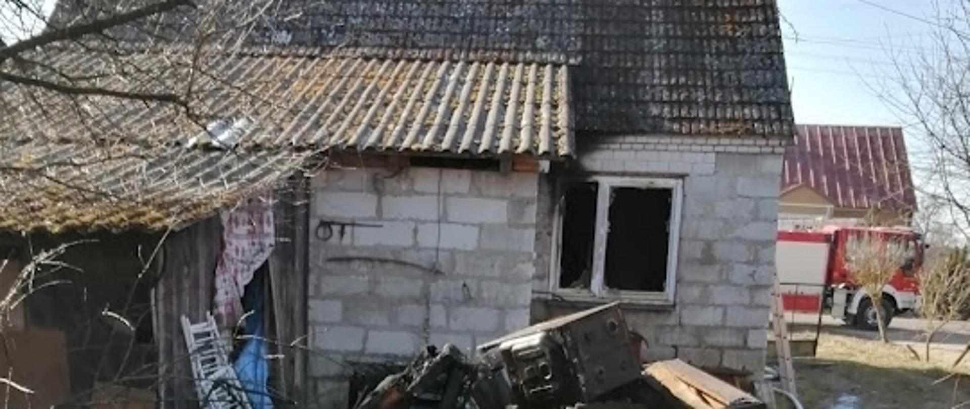 Na zdjęciu widać nadpalone elementy wyposażenia domu wyrzucone na zewnątrz 