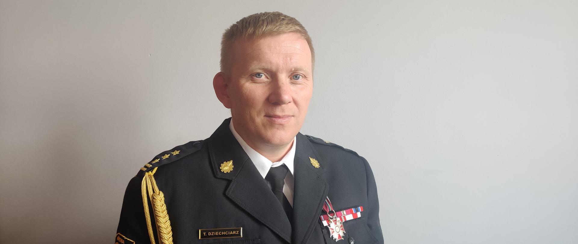 Na zdjęciu widać komendanta miejskiego w umundurowaniu wyjściowym ze sznurem galowym