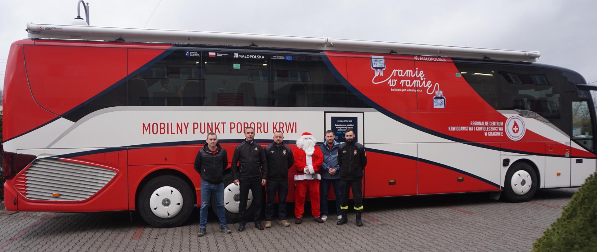 Na zdjęciu widoczne osoby które oddał honorowo krew na tle autobusu do poboru krwi