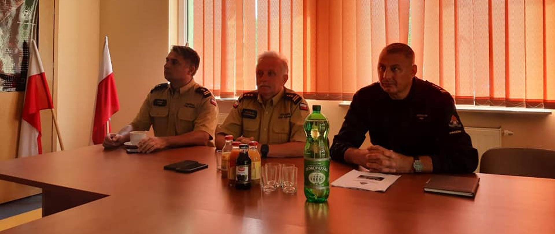 Zdjęcie przedstawia funkcjonariuszy PSP podczas podsumowania ćwiczeń powiatowych pk. "POWÓDŹ 2022". 