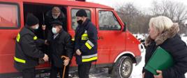 OSP Przedmieście pomaga wysiąść z samochodu strażackiego 