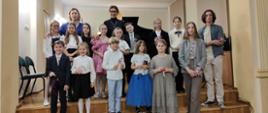 Zdjęcie grupowe wszystkich uczestników koncertu uczniów klas fortepianu P. A. Bartkiewicz-Brzozowskiej i P. K. Mąki-Żelazko - 28 listopada 2023