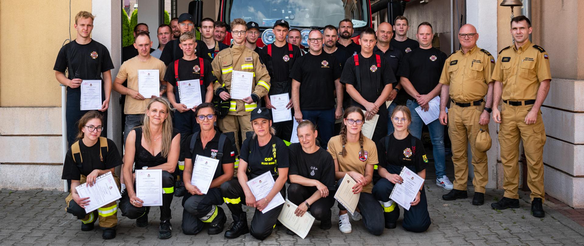 Na zdjęciu druhny i druhowie ustawienie do wspólnego zdjęcia pamiątkowego z wręczonymi zaświadczeniami ukończenia kursu podstawowego