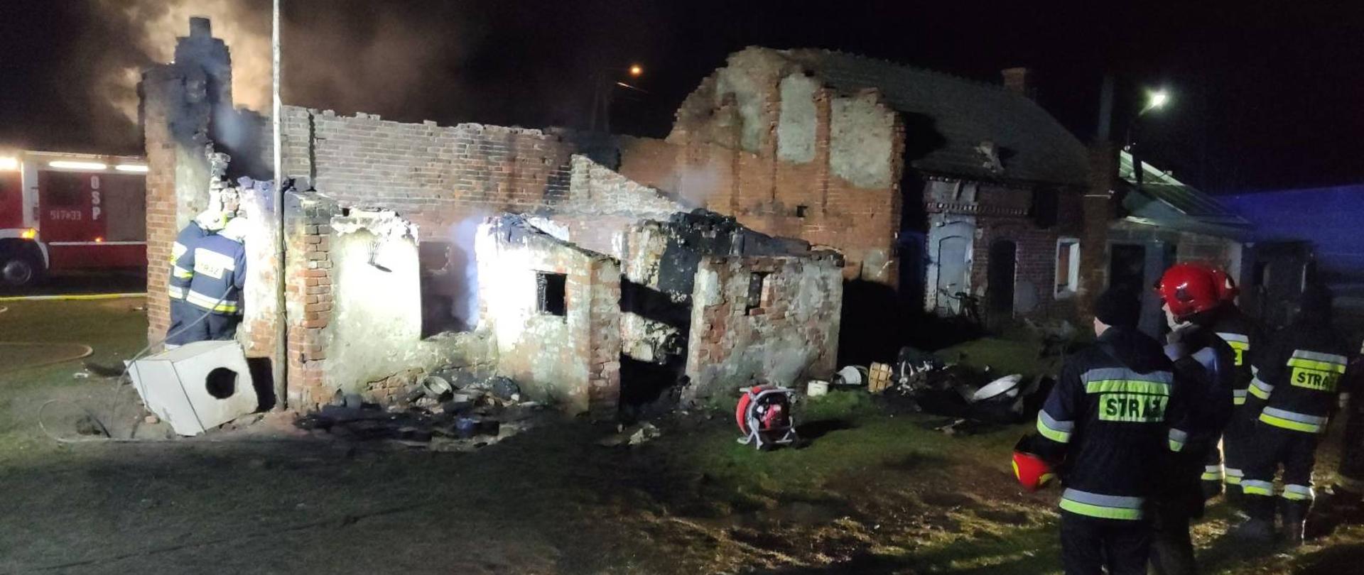 Stradomia Dolna - pożar budynku mieszkalnego. Na zdjęciu widać spalony budynek. Widoczne gołe mury, dach całkowicie zawalony. Strażacy dogaszają pogorzelisko. 