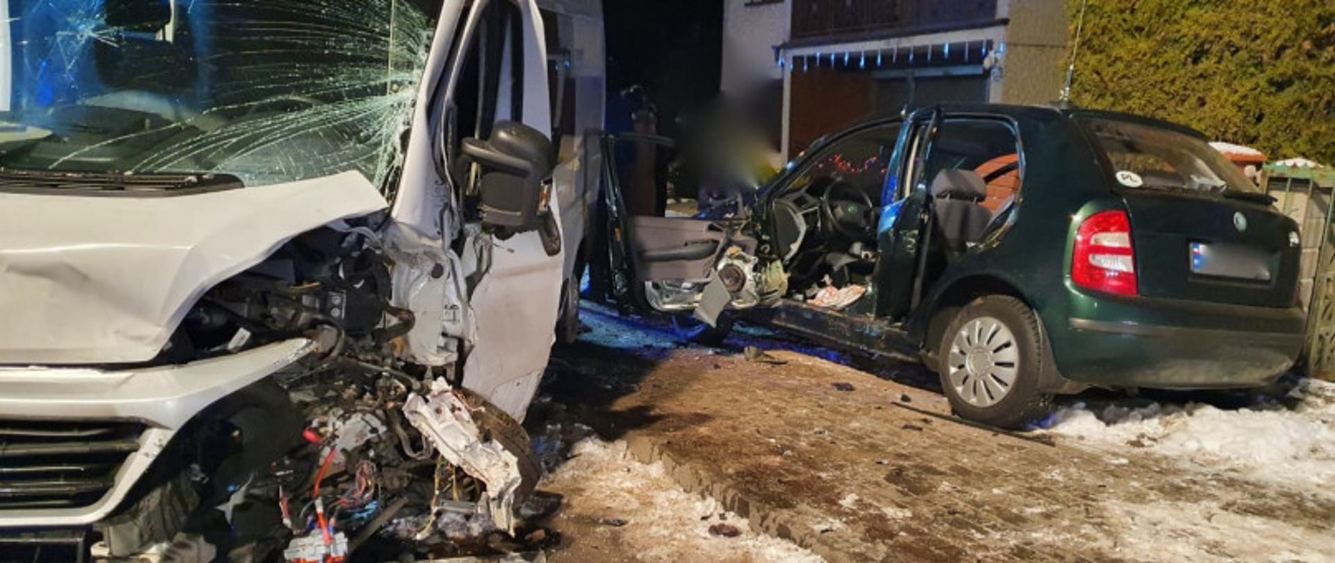 Zdjęcie przedstawia dwa rozbite samochody po zderzeniu