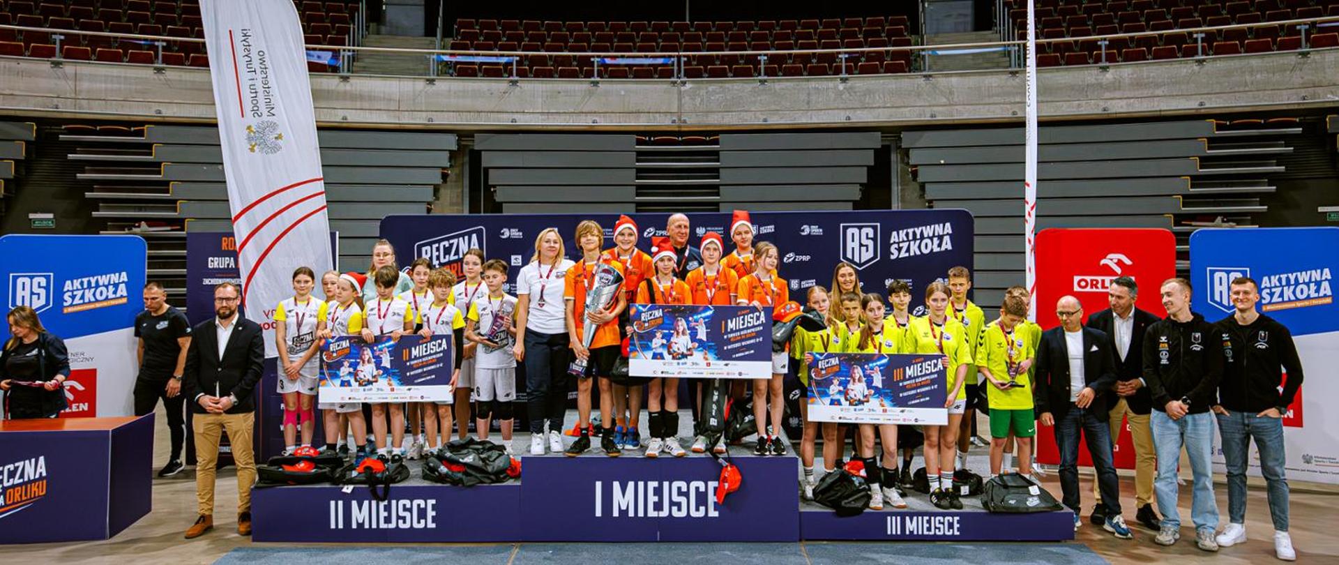 Three top teams of the Handball at Orlik pitches tournament stand on the podium.