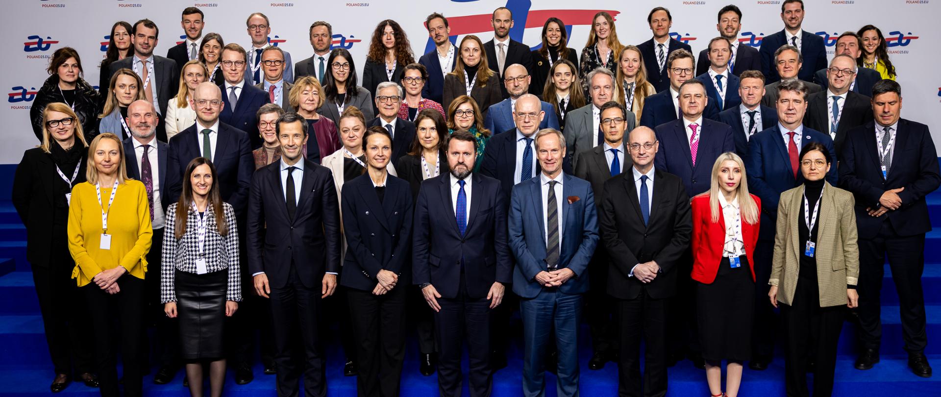 Wiele osób ustawionych w rzędach pozuje do wspólnego zdjęcia.