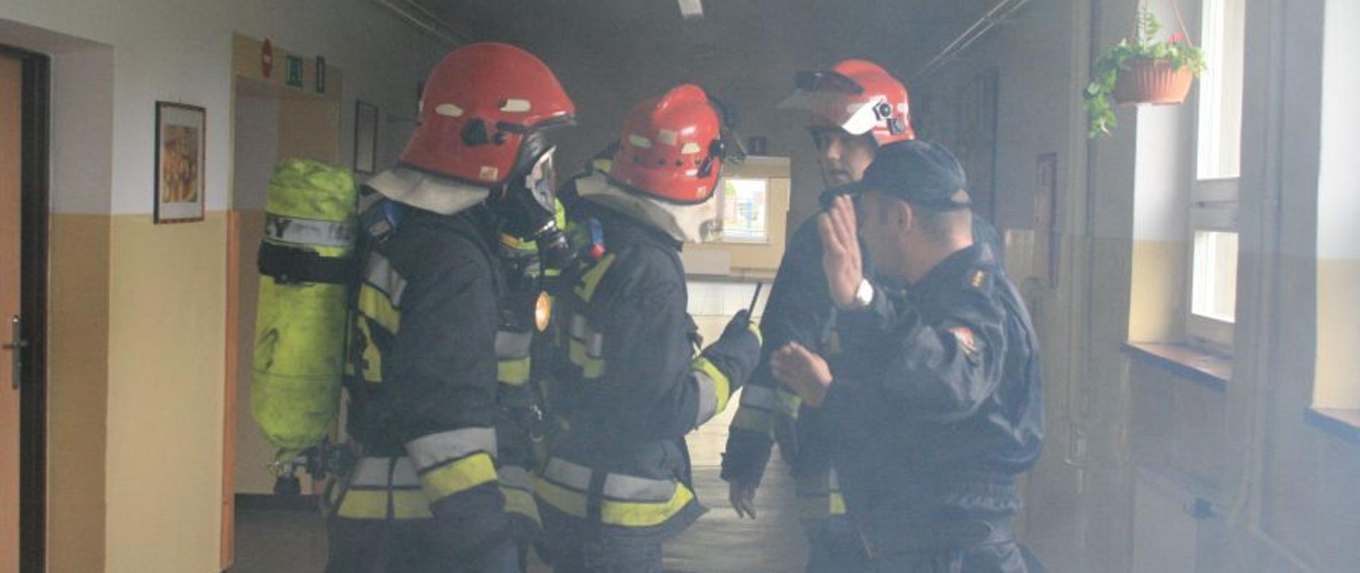 Strażacy na korytarzu w szkole