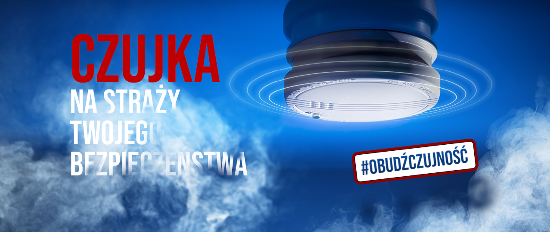 Czujka dymu i czadu zamontowana na suficie, obok napis: czujka na straży twojego bezpieczeństwa #obudźczujność