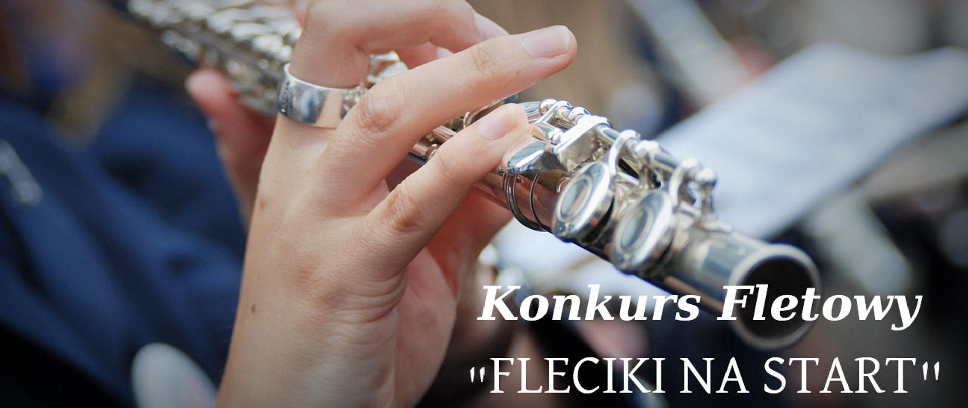 Ręka trzymająca flet poprzeczny, obok napis Konkurs Fletowy "Fleciki na start"