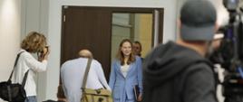 In the photo, Minister Katarzyna Pełczyńska-Nałęcz enters the conference room. In the foreground, journalists take photos