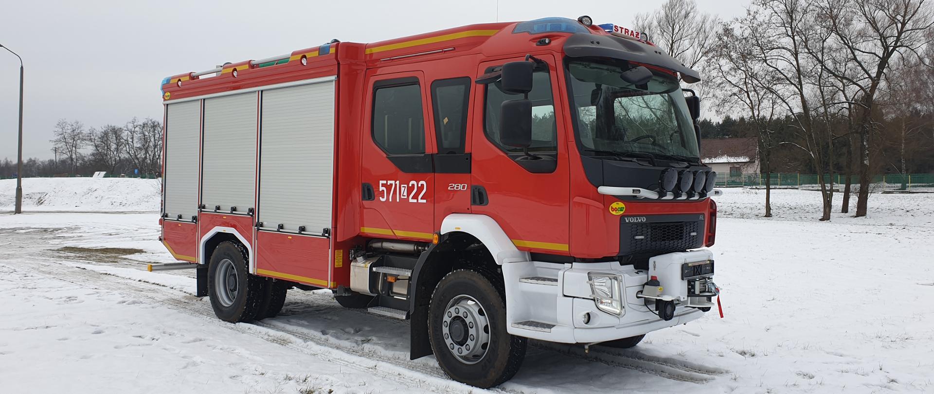 Na zdjęciu widać samochód ratowniczo gaśniczy Volvo o numerach operacyjnych 571z22, należący do Komendy Powiatowej Państwowej Straży Pożarnej w Wałczu. Samochód stoi na zaśnieżonym placu. Pojazd widać pod kątem, przód i prawy bok.