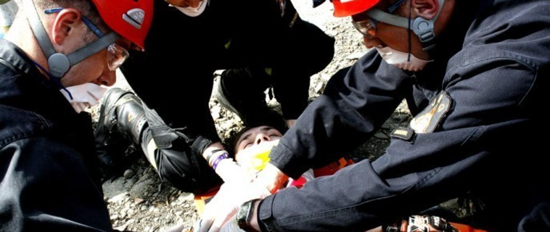 Strażacy z KP PSP Limanowa udzielają pomocy przedmedycznej osobie poszkodowane.