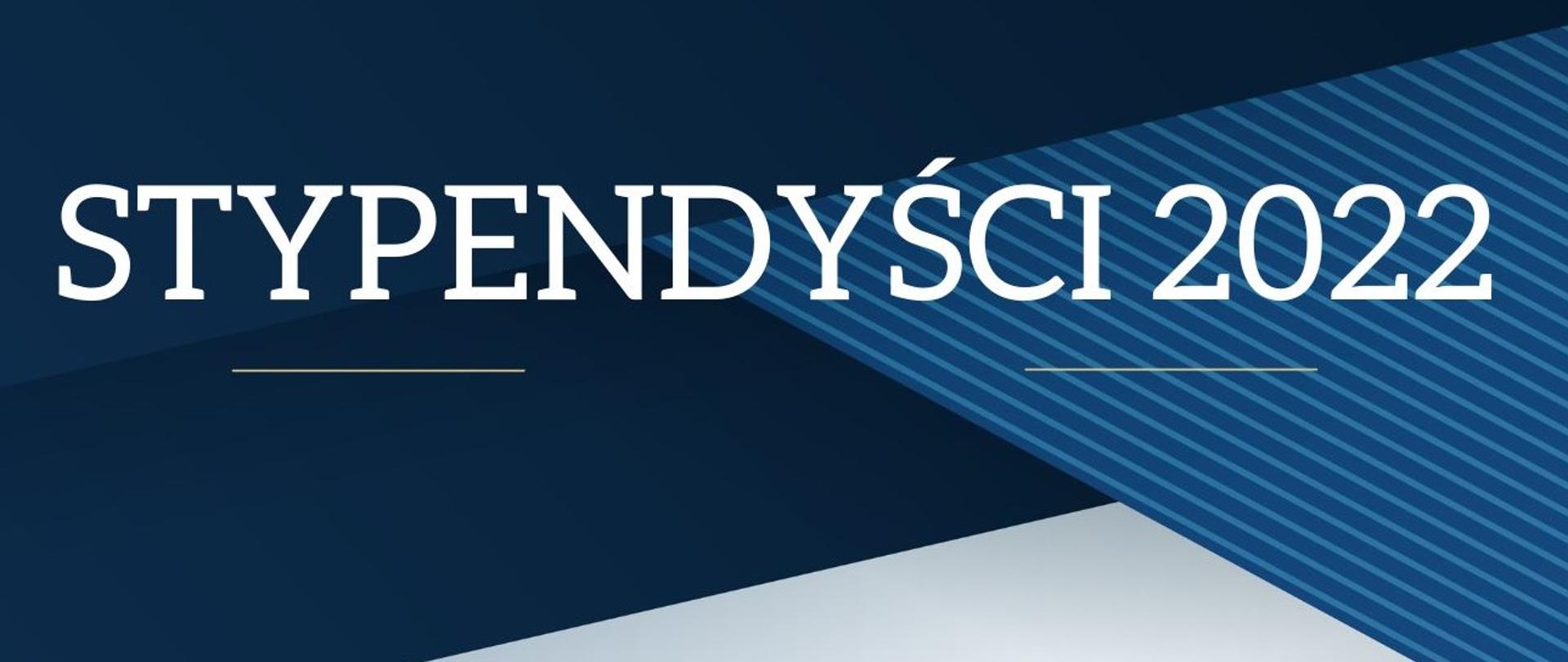 Napis stypendyści na niebieskim tle