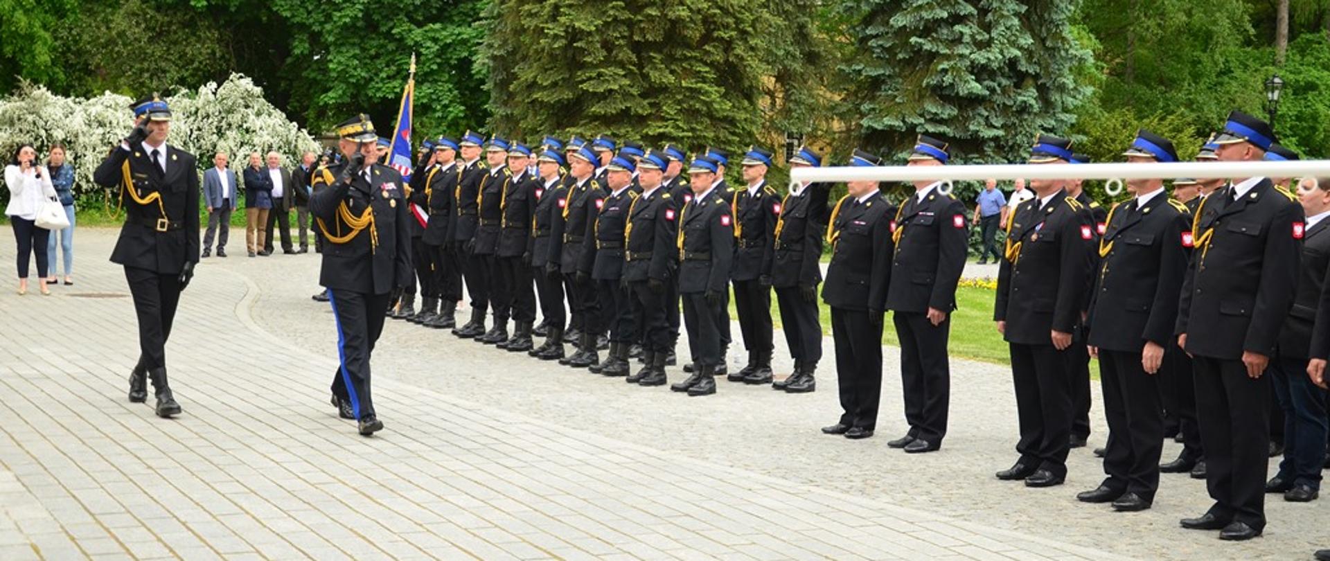 Przed frontem pododdziałów maszeruje generał wraz z dowódcą uroczystości. Generał dokonuje przeglądu pododdziału.