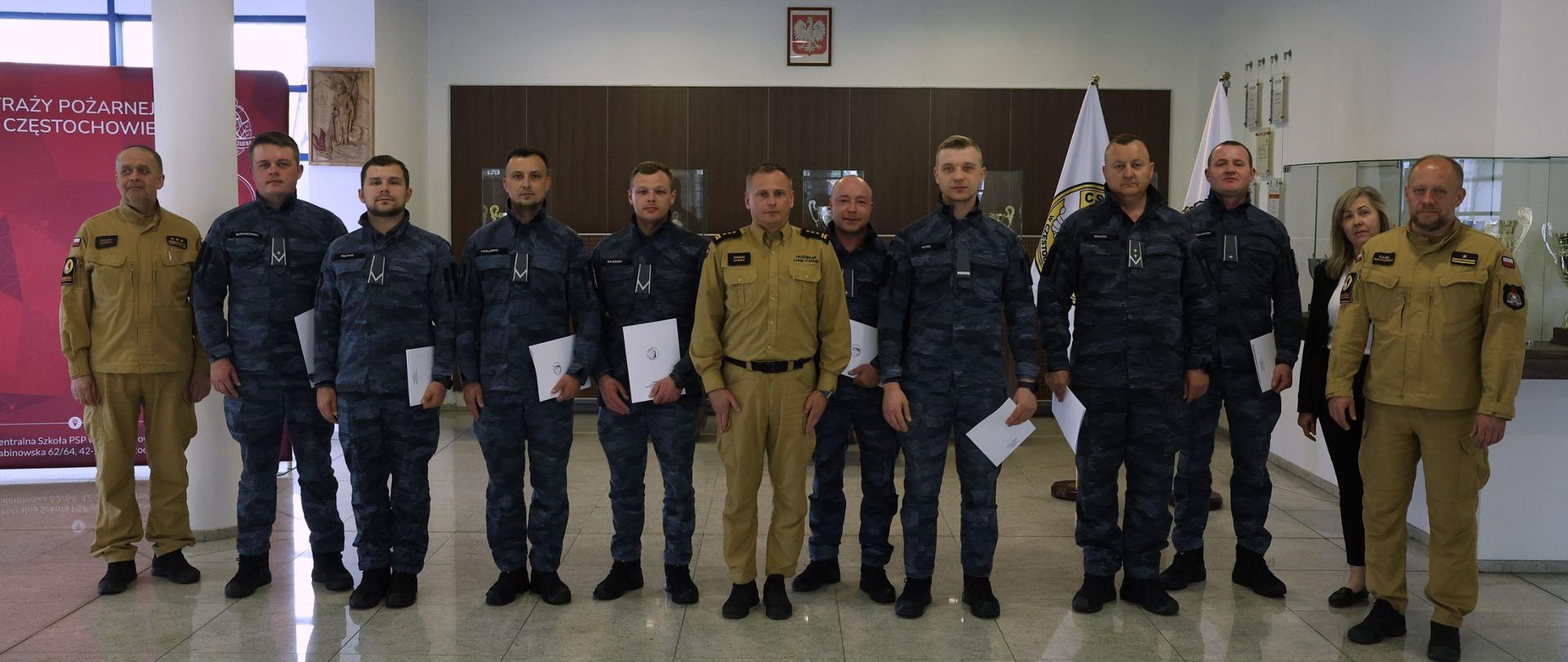 Pamiątkowe zdjęcie grupowe funkcjonariuszy Straży Marszałkowskiej (8 osób) będących uczestnikami kursu z obsługi systemów sygnalizacji pożaru, w towarzystwie Zastępcy Komendanta Centralnej Szkoły PSP, kobiety oraz dwóch oficerów CS PSP